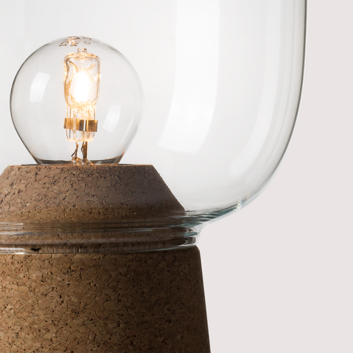 Picia table lamp designed by Enrico Zanolla in clear glass and natural cork, transparent cable, detail of the junction between cork and glass, beautiful match of curves